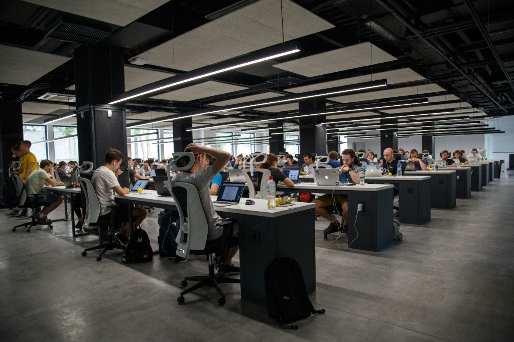 Escritório com equipe trabalhando — metáfora dos 320 especialistas do FounderSquad